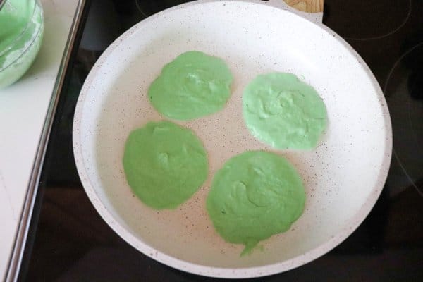 green pancake batter in skillet