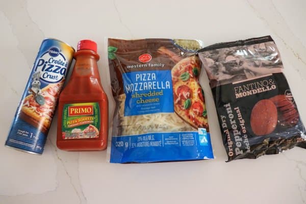 Halloween Deep Dish Pizza Ingredients on a white counter.