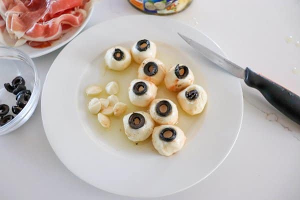 Mozza ball eyes on a white plate.