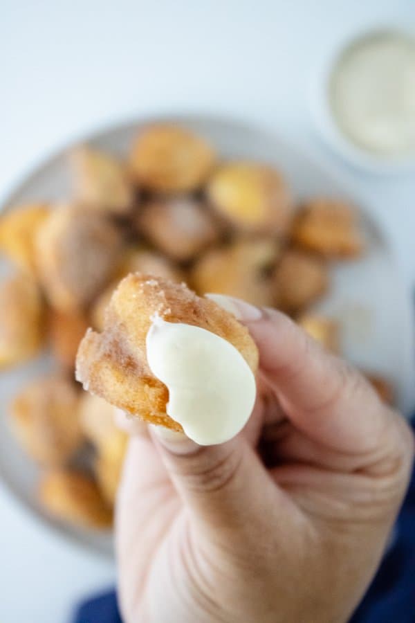 A close up image of an air fryer cinnamon bite with icing.