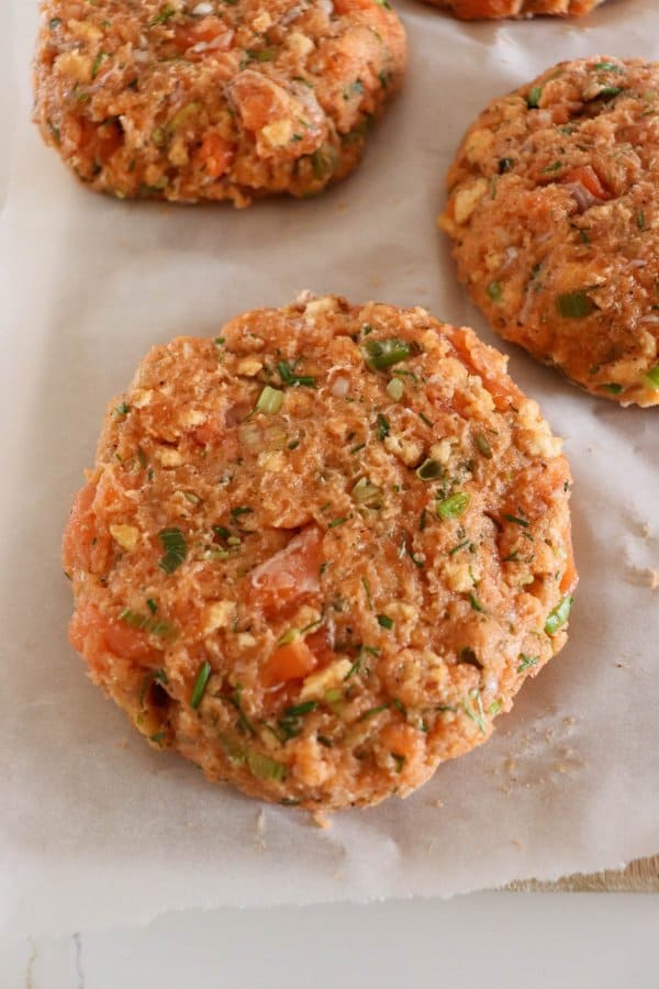 Close up of raw salmon burger patty.