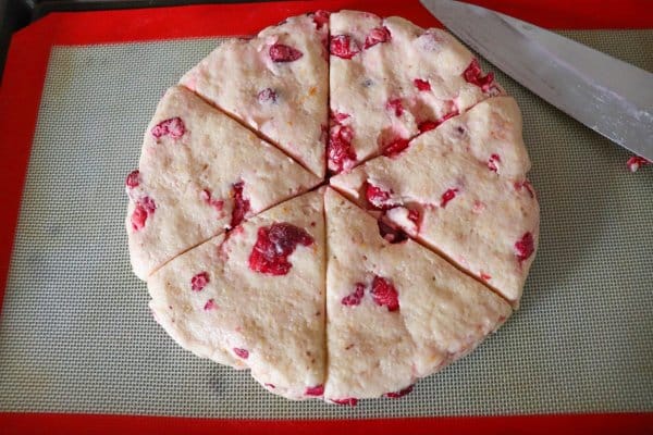 Cranberry scone dough cut into wedges