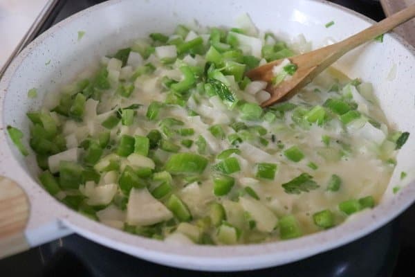 Onion and celery in frying pan