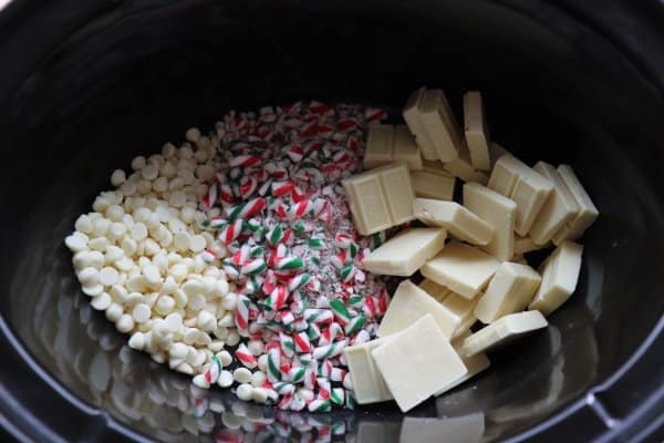 White chocolate and candy canes in a clack crockpot.