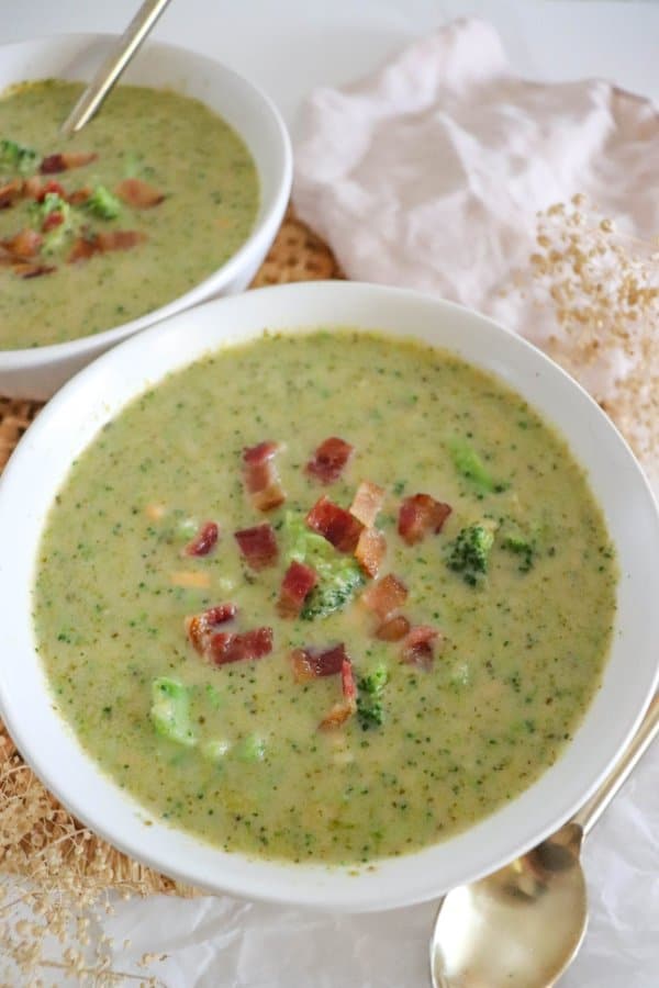 Crockpot broccoli soup garnished with bacon bits.