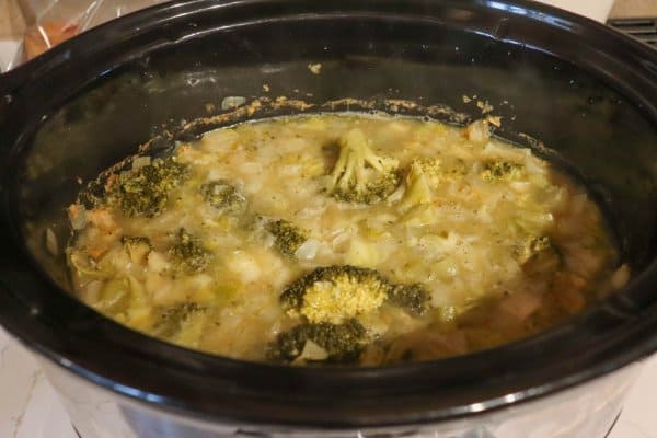 Cooked broccoli cheddar soup ingredients in a large crockpot.