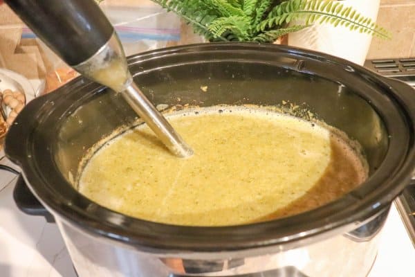 A submersion blender is used in the broccoli cheddar soup.