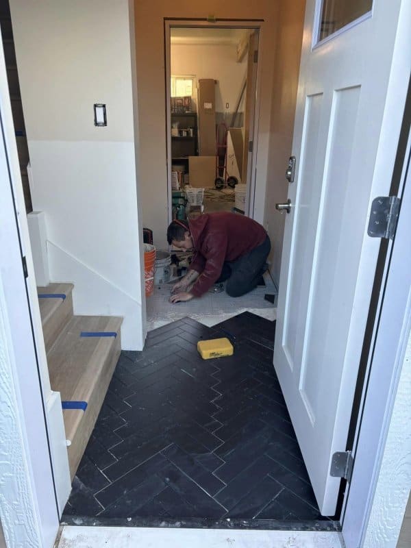 Vince tiling the mudroom