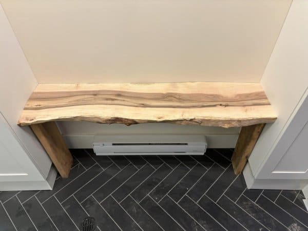 The live edge bench is cut to length to fit between two Ikea cabinets.