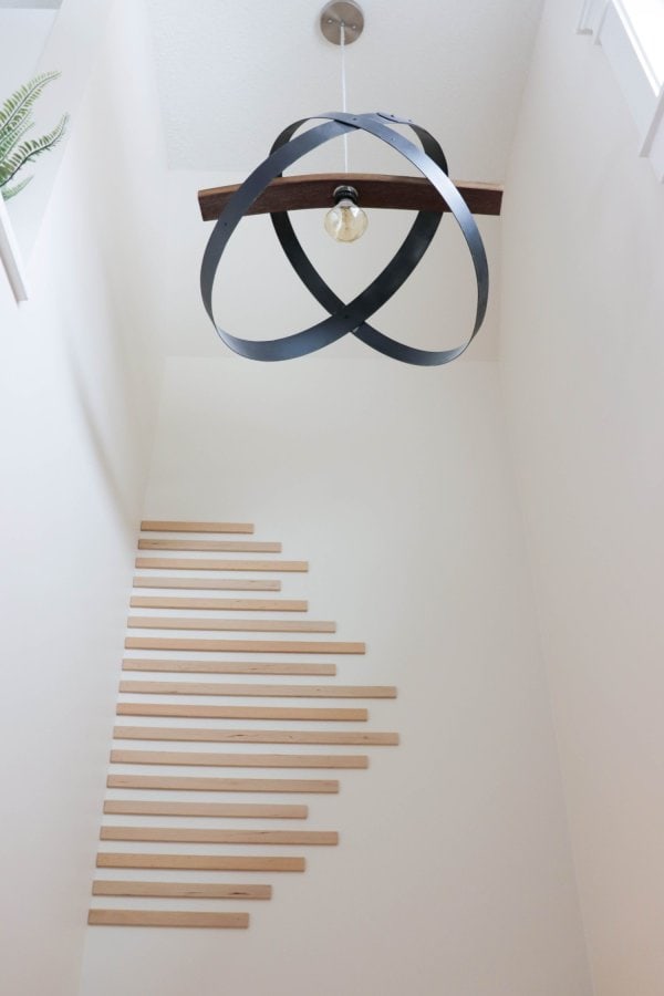 Different lengths of wood trim are added to a stairwell to create an easy accent wall.