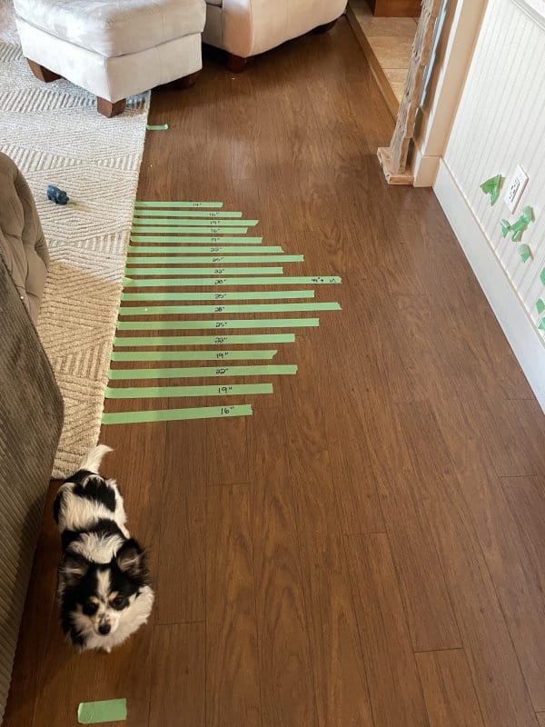 Painter tape is put in strips on the floor to plan out the accent wall.