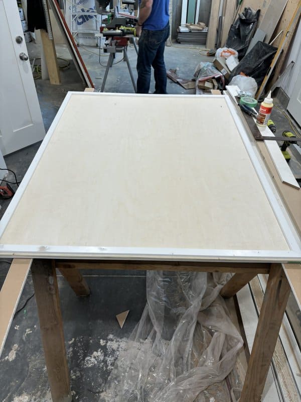 Plywood with trim frame in a workshop.