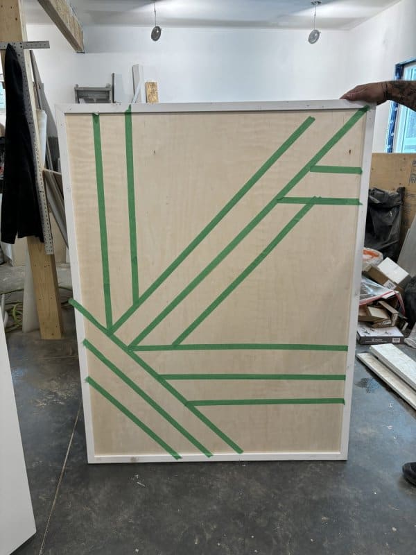 Using painters tape to map out a graphic design.