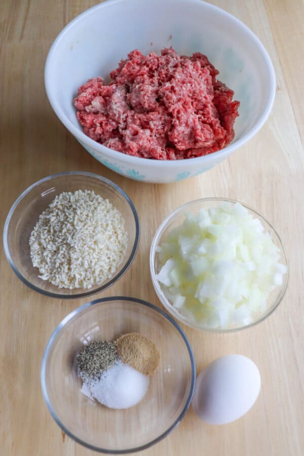 The ingredients to make air fryer burgers in separate bowls.