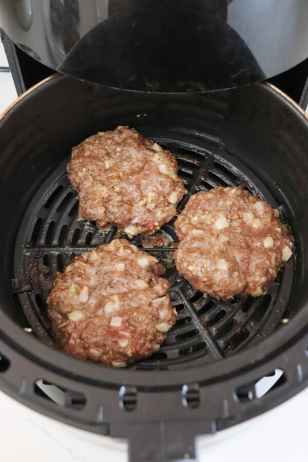 Burgers cooked in the air fryer basket.
