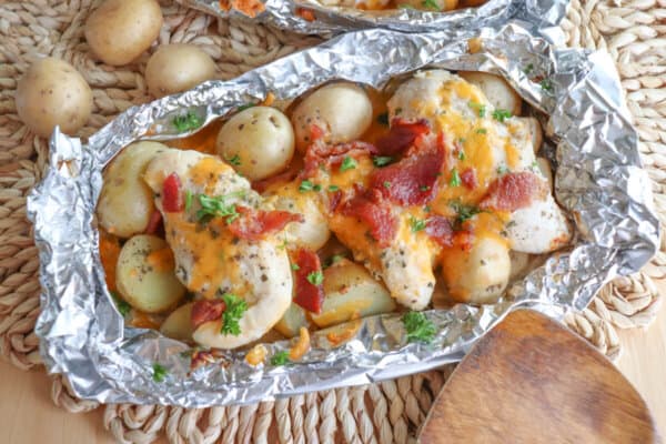 Chicken Bacon Ranch Foil Packs Chicken and baby potatoes covered in ranch seasoning, bacon bits and melted cheese in a foil packet.