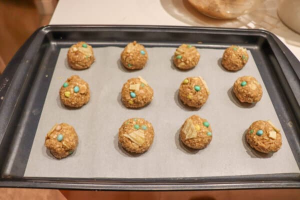 Easter kitchen sink cookie dough balls on a parchment paper lined baking sheet.