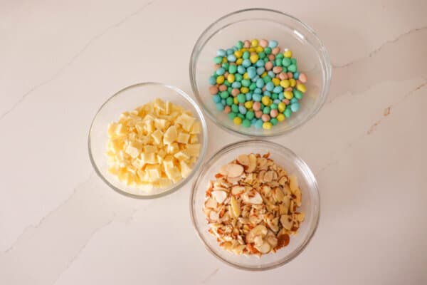 Easter cookie ingredients in clear glass bowls.