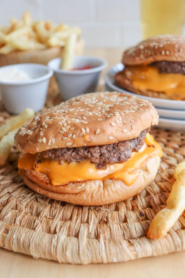 Copycat five guys burger with melted American cheese on a sesame seed bun.