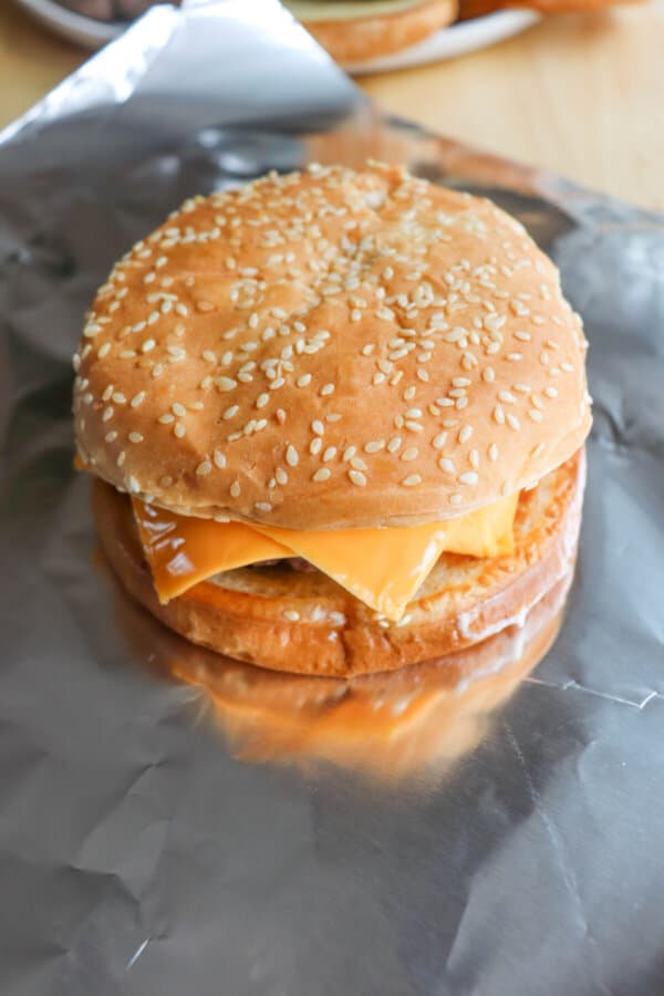 Five guys burger assembly on foil.