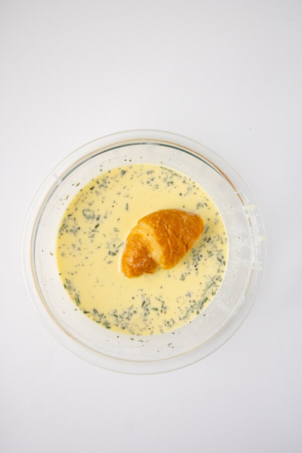 Dipping croissants in egg mixture