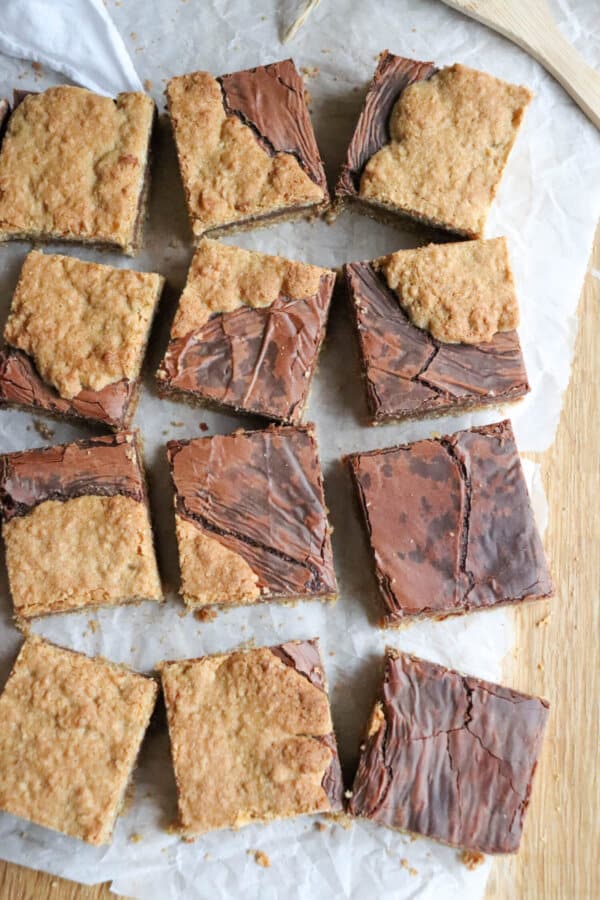 Starbucks Oat Bars cut into squares on parchment paper. 