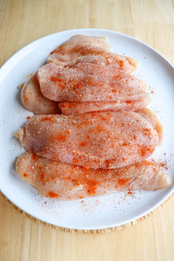 Raw chicken breasts coated in cajun seasoning.