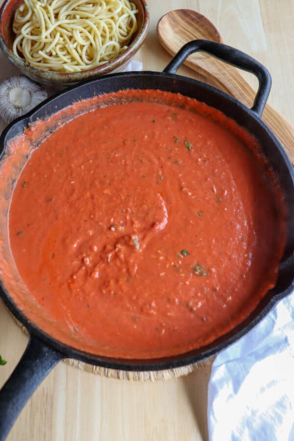 Creamy tomato sauce in a cast iron skillet.
