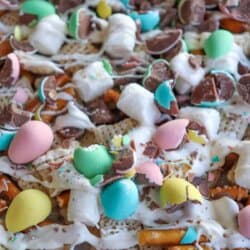 Easter snack mix with chex cereal, pretzels and chopped mini eggs drizzled with white chocolate.