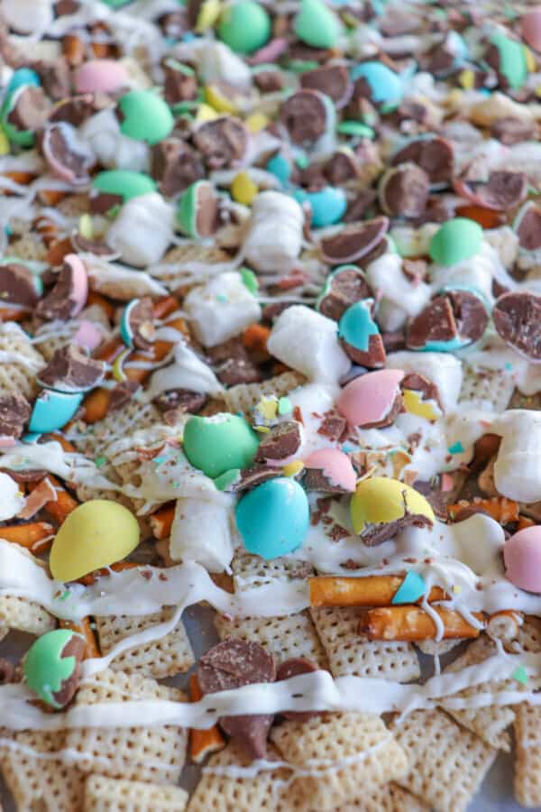 Easter snack mix with chex cereal, pretzels and chopped mini eggs drizzled with white chocolate.