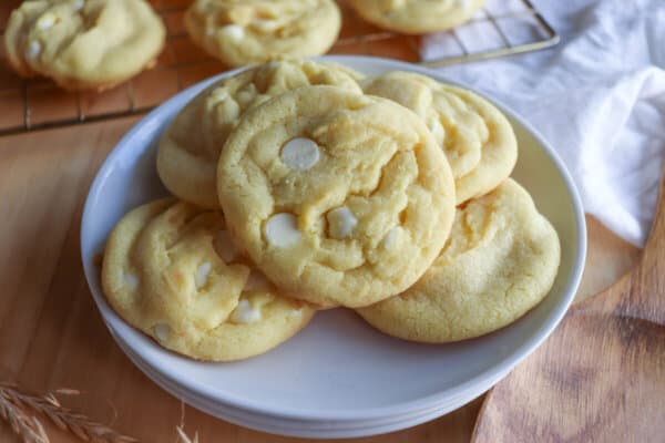 Yellow lemon pudding cookies on a white plate.