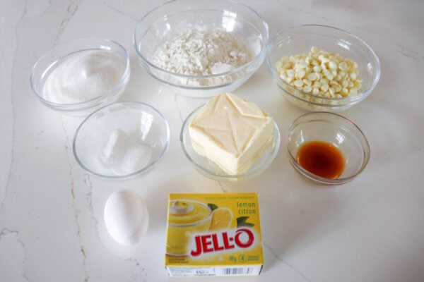 Lemon pudding cookie ingredients in clear glass bowls.