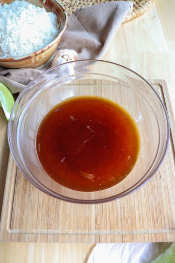 Homemade sweet chili sauce in a clear glass bowl.