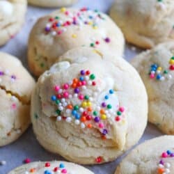Vanilla pudding cookies with colorful rainbow sprinkles on top.