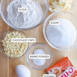 Ingredients for butterscotch pudding cookies in clear glass bowls on a wooden table.