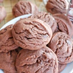 Baked chocolate pudding cookies on a white plate.