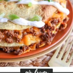 Corn tortillas layered with ground beef and melty cheese topped with sour cream and dipped green onions.