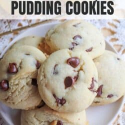 Chocolate chip cookies piled on a white plate.