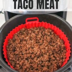 Ground beef seasoned with taco spices and cooked in the basket of an air fryer with a red liner.