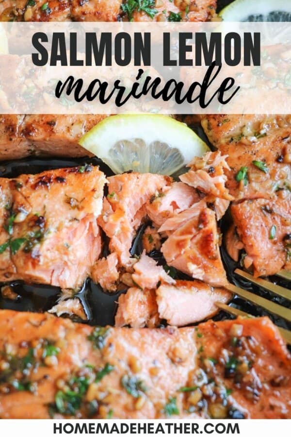 Salmon fillets in a cast iron skillet topped with fresh parsley and lemon slices.
