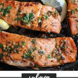 Salmon fillets in a cast iron skillet topped with fresh parsley and lemon slices with a text box that says salmon lemon marinade.