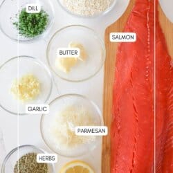 Ingredients for herb crusted salmon in clear glass bowls on a white counter.