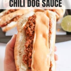 Chili cheese dog held in a hand.