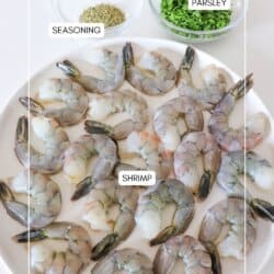 Ingredients for garlic butter pan grilled shrimp in clear glass bowls with a plate full of raw, prepared shrimp.