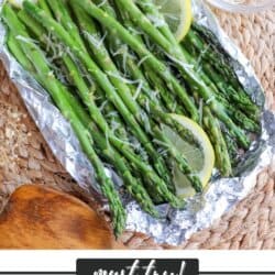 Asparagus spears topped with lemon slices and shredded mozzarella in a foil packet.