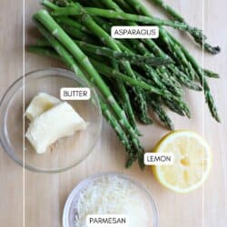 Ingredients for asparagus foil packs in clear glass bowls on a wooden table.