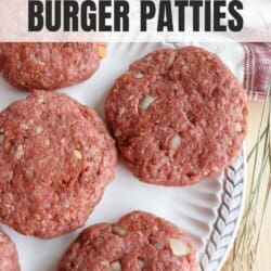 Raw hamburger patties on a white plate.