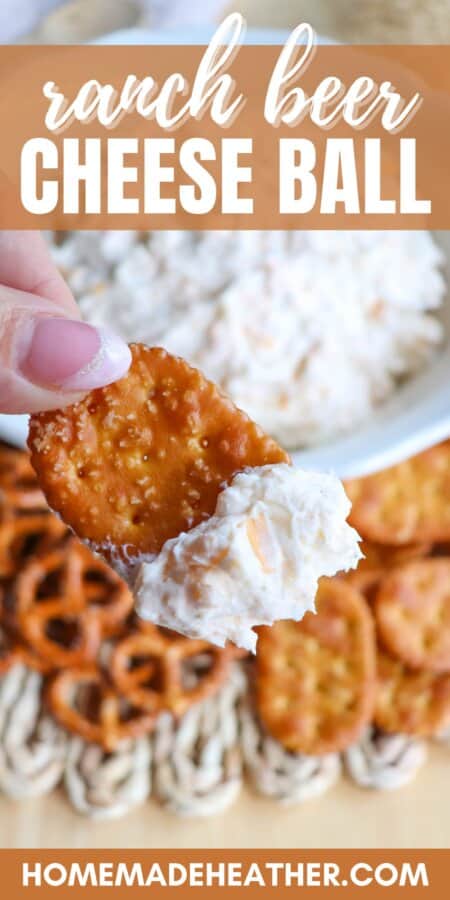 Creamy ranch beer cheese dip in a white bowl, surrounded by pretzels and crackers with a hand holding a pretzel cracker with dip on it and text overlay.