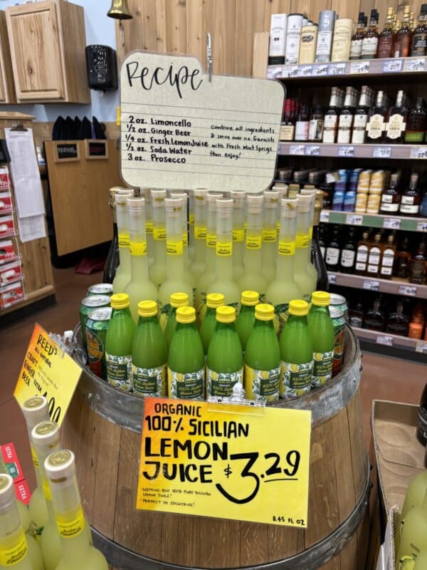 Display at Trader Joes with lemon juice , limoncello and a sign with a cocktail recipe.