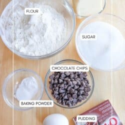 Ingredients for chocolate pudding cookies in clear glass bowls in a wood table.